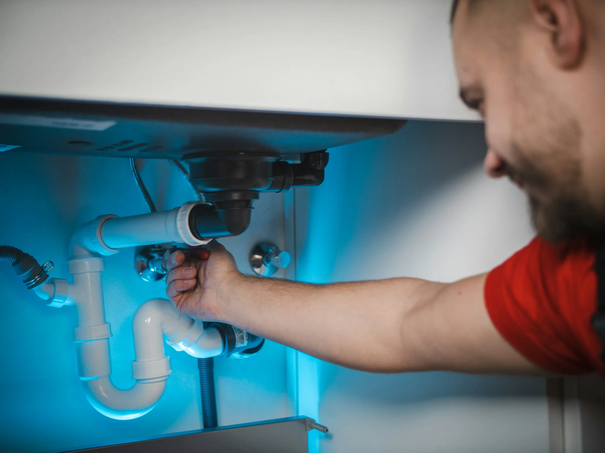 Close view of hands fitting a cartridge into a residential water filter housing