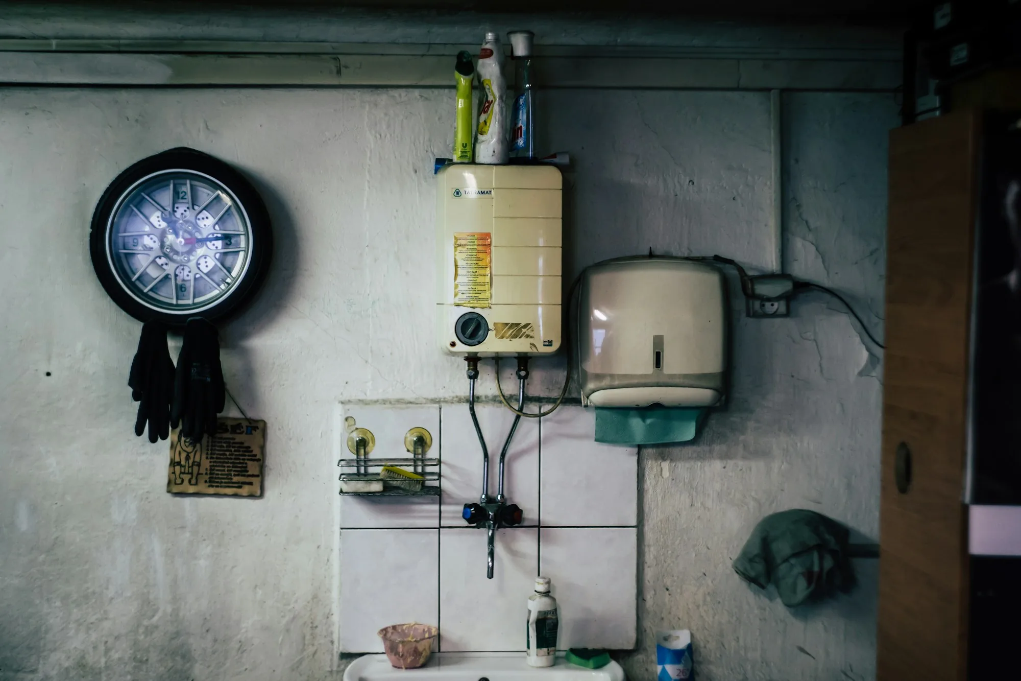 Home utility wall with a tankless heater, pressure gauge and water fittings