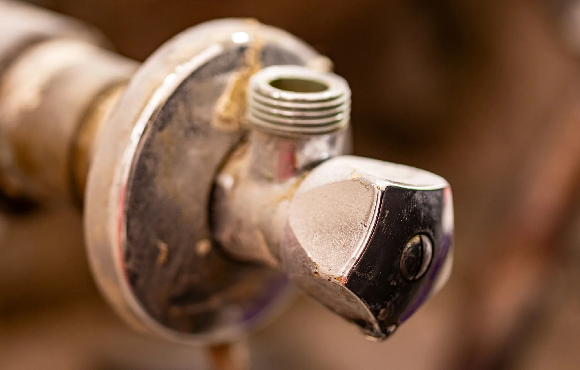 Heavy mineral scale crusted around a brass tap outlet
