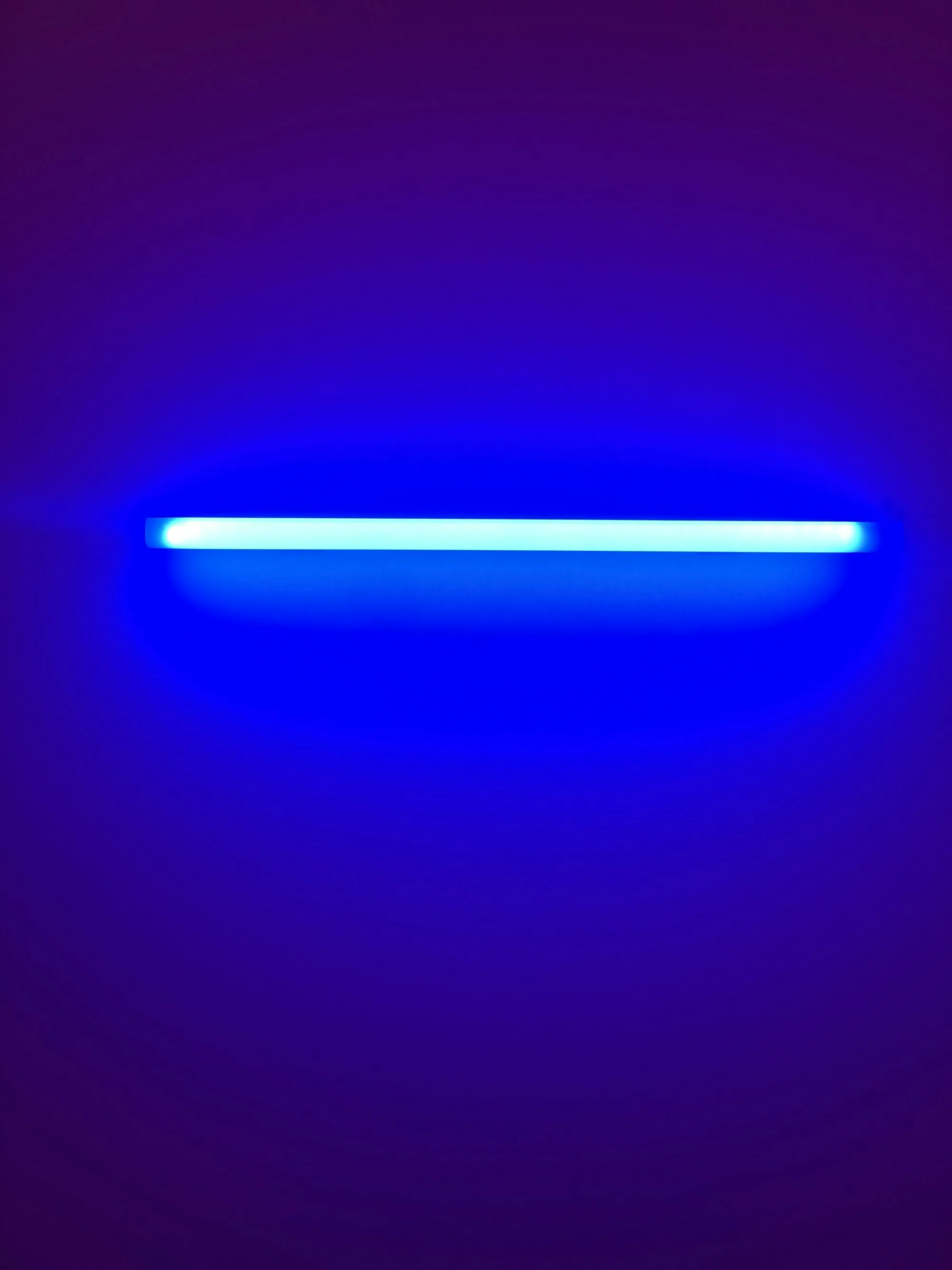 Ultraviolet lamp glowing blue against a dark background